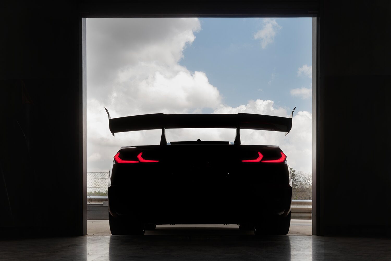 Rear End View of the 2026 Chevy Corvette ZR1X Pulling Out of a Warehouse