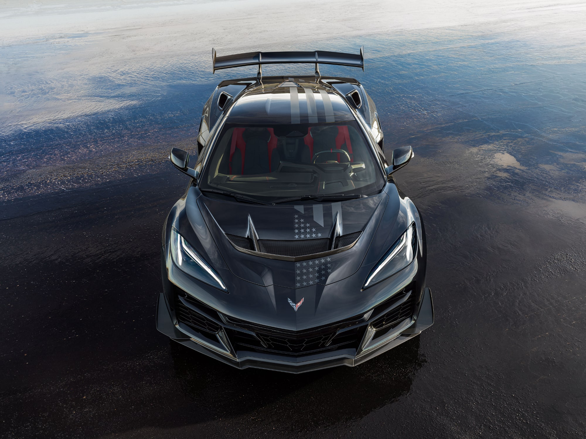 A Dark Blue Chevrolet Corvette ZR1x from the Stars and Steel Collection on a Wet Runway.