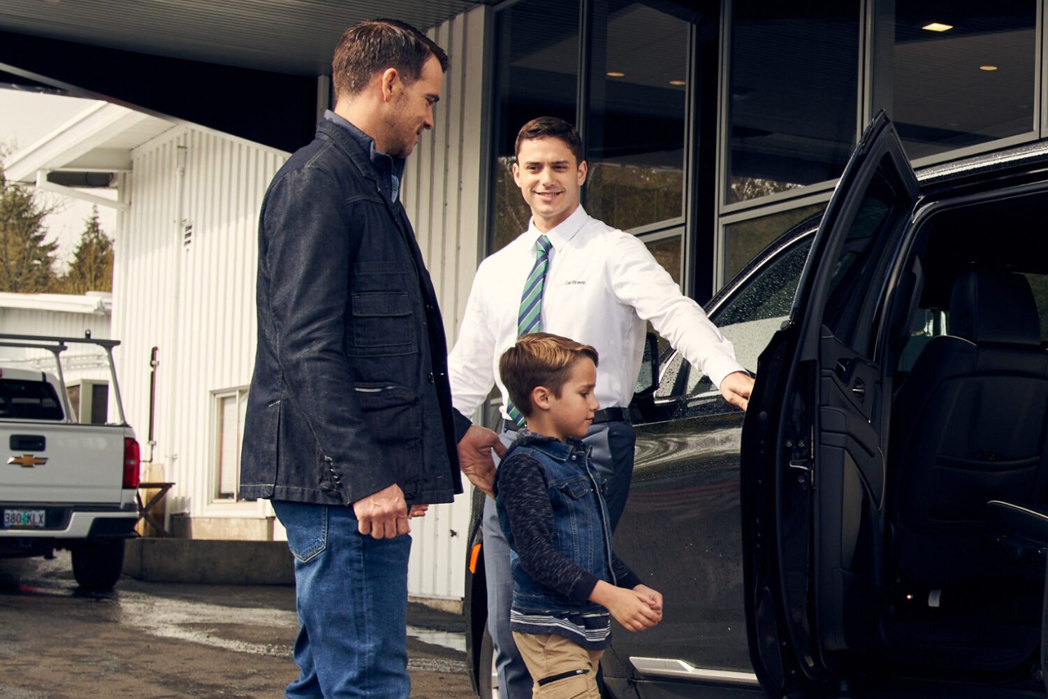 A Father and Son Viewing a Chevy CarBravo SUV at a Dealership