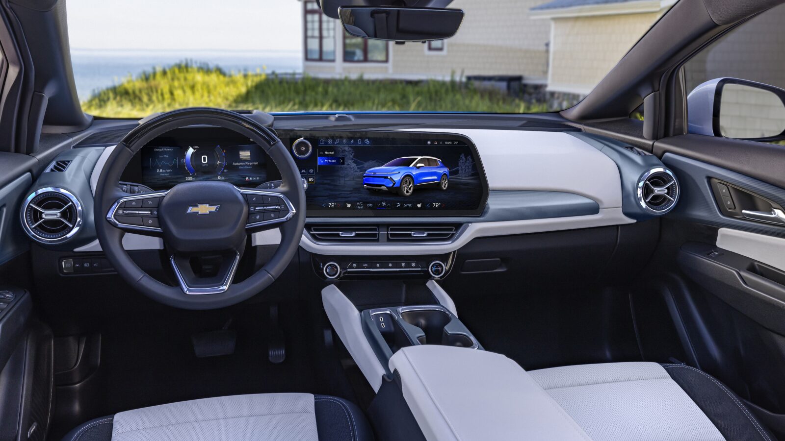The Interior of a Chevrolet Equinox EV Featuring a Wide Dashboard With Digital Screens and Two-Tone Seats.