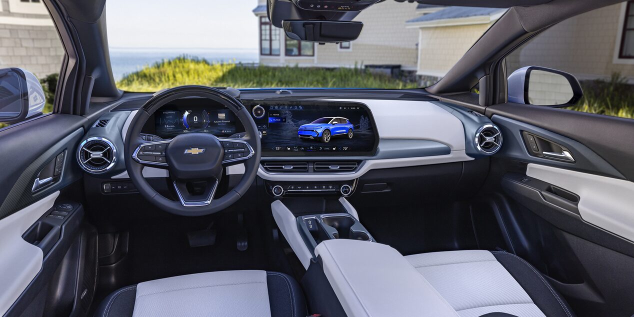 The Detailed Interior Cockpit of a Chevrolet Equinox EV, Showing the Steering Wheel and Dual Digital Displays.