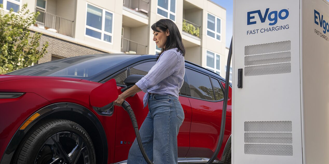 A Woman Using an EVgo Charging Station