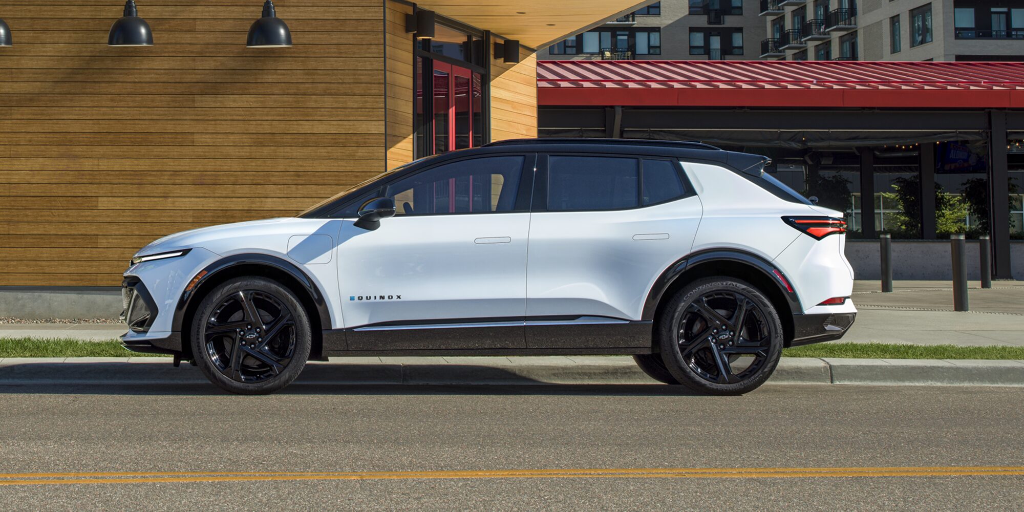 2026 Chevy Equinox EV Side Profile Parked Next to a Restaurant