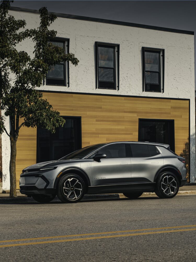 2026 Chevy Equinox EV Side Profile Parked in Front of a Storefront