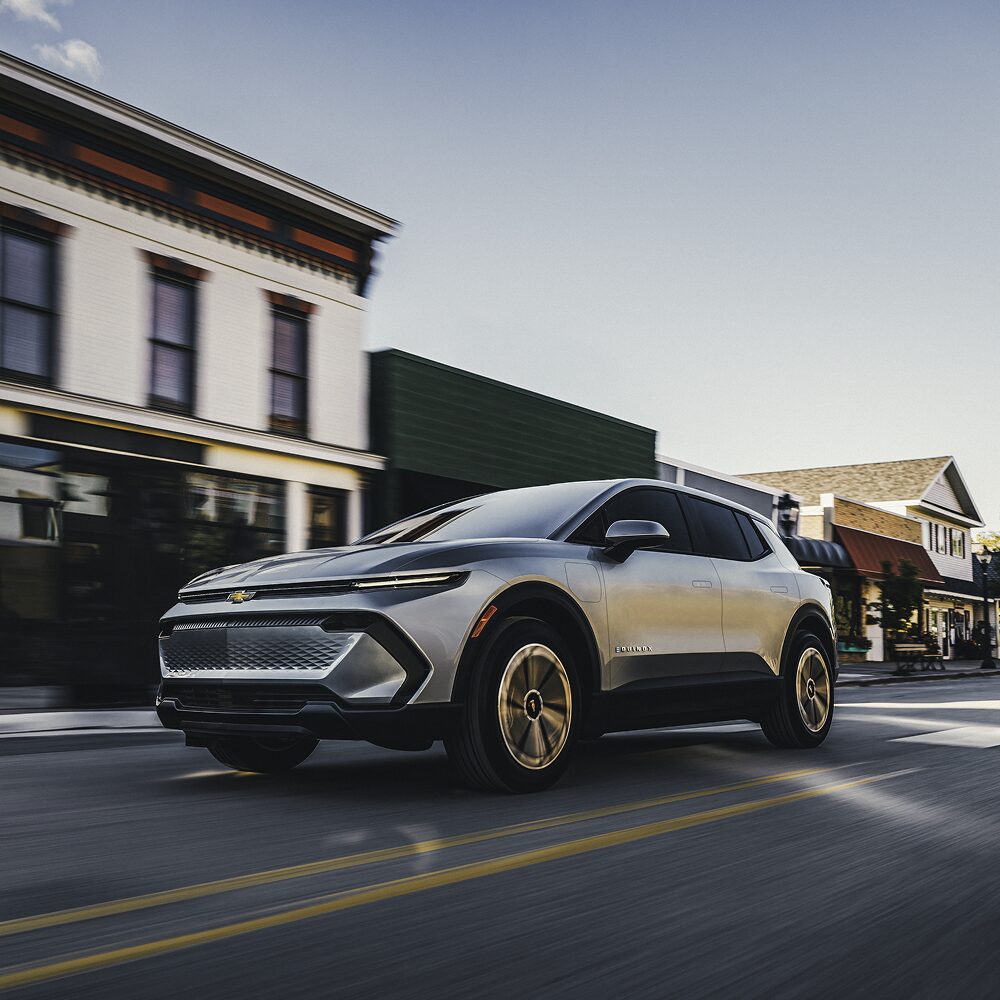 2026 Chevy Equinox EV Driving Through a Small Town
