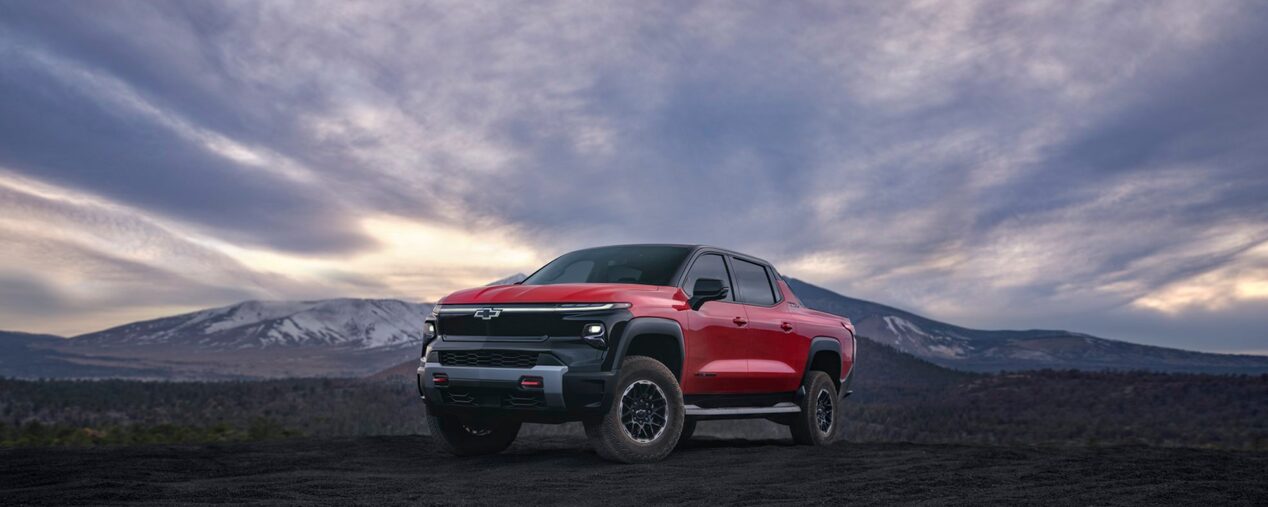 2026 Chevy Silverado Parked on Dark Rocky Terrain with a Dramatic Sky in the Background