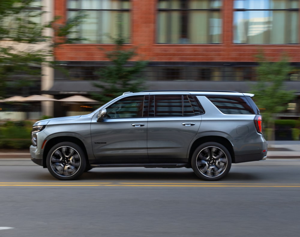 2025 Chevy Tahoe Side Profile View While Driving Through a Downtown Area