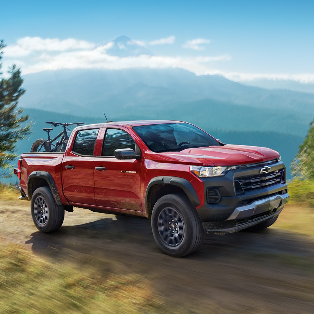 2025 Chevy Silverado 1500 Parked Off-Road on Rocky Terrain with Mountains Nearby