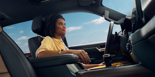 Woman Using Hands-Free Driving Feature Inside a Chevy SUV