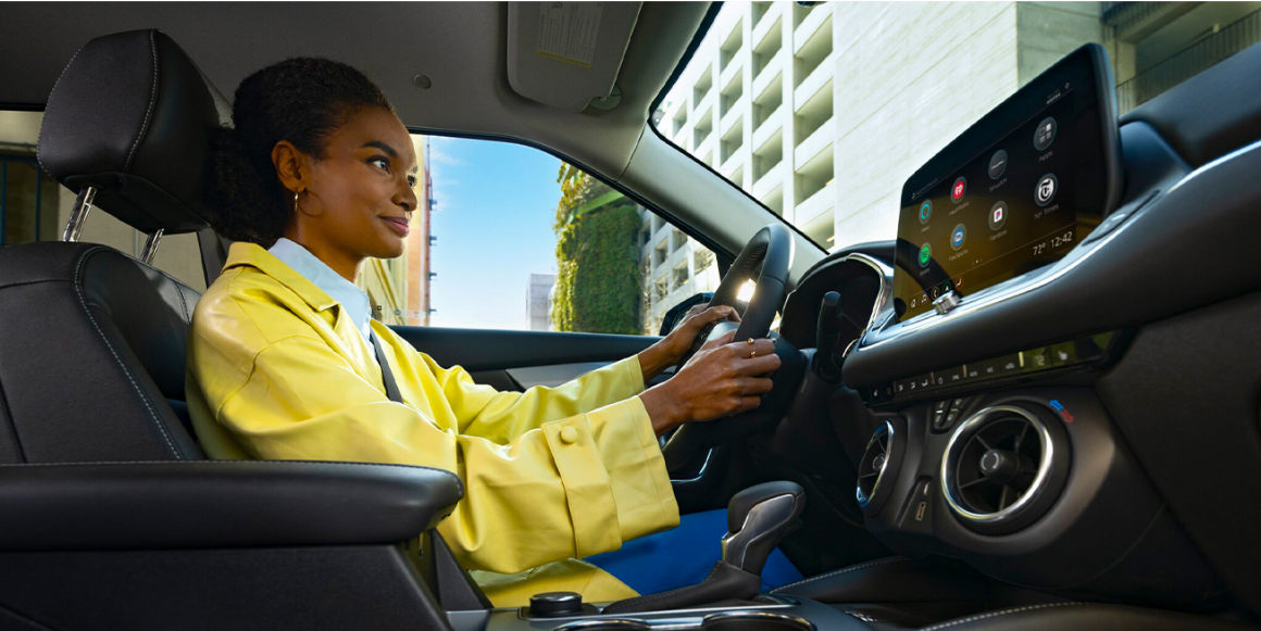 Woman Using Hands-Free Driving Feature Inside a Chevy SUV