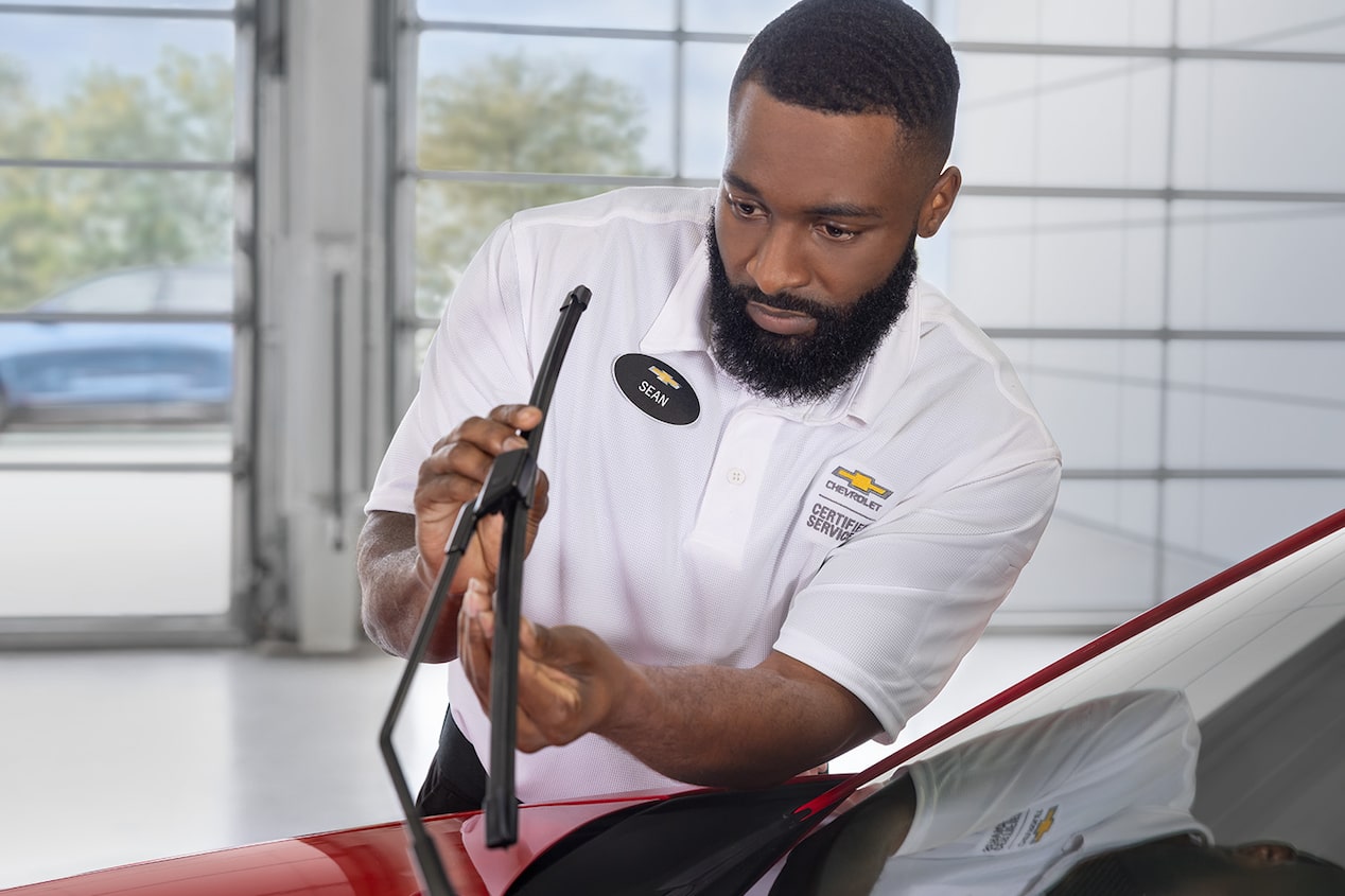 A Mechanic Fixing a Windshield Wiper on a Chevrolet Vehicle