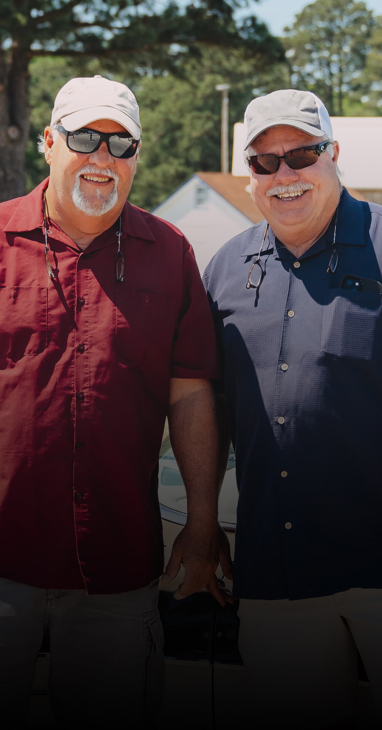 Scotty Hooper and Paul Atkins Pose in Front of a Vintage Chevy Car