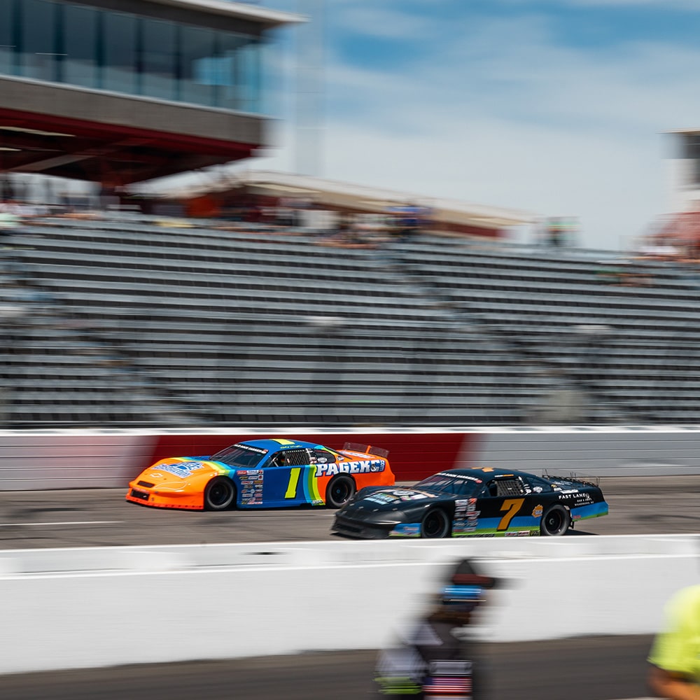 View of Two Vehicles on a Race Track