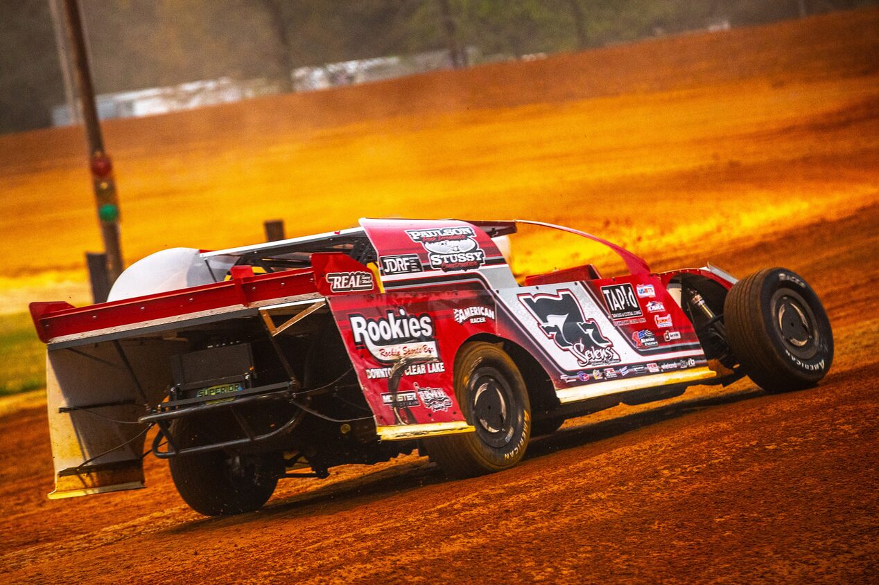 Left Rear View of a Race Car on a Dirt Track