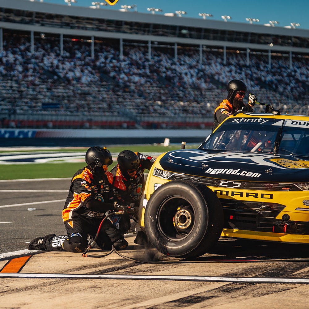 Two Crew Members Working on a Camaro Race Car