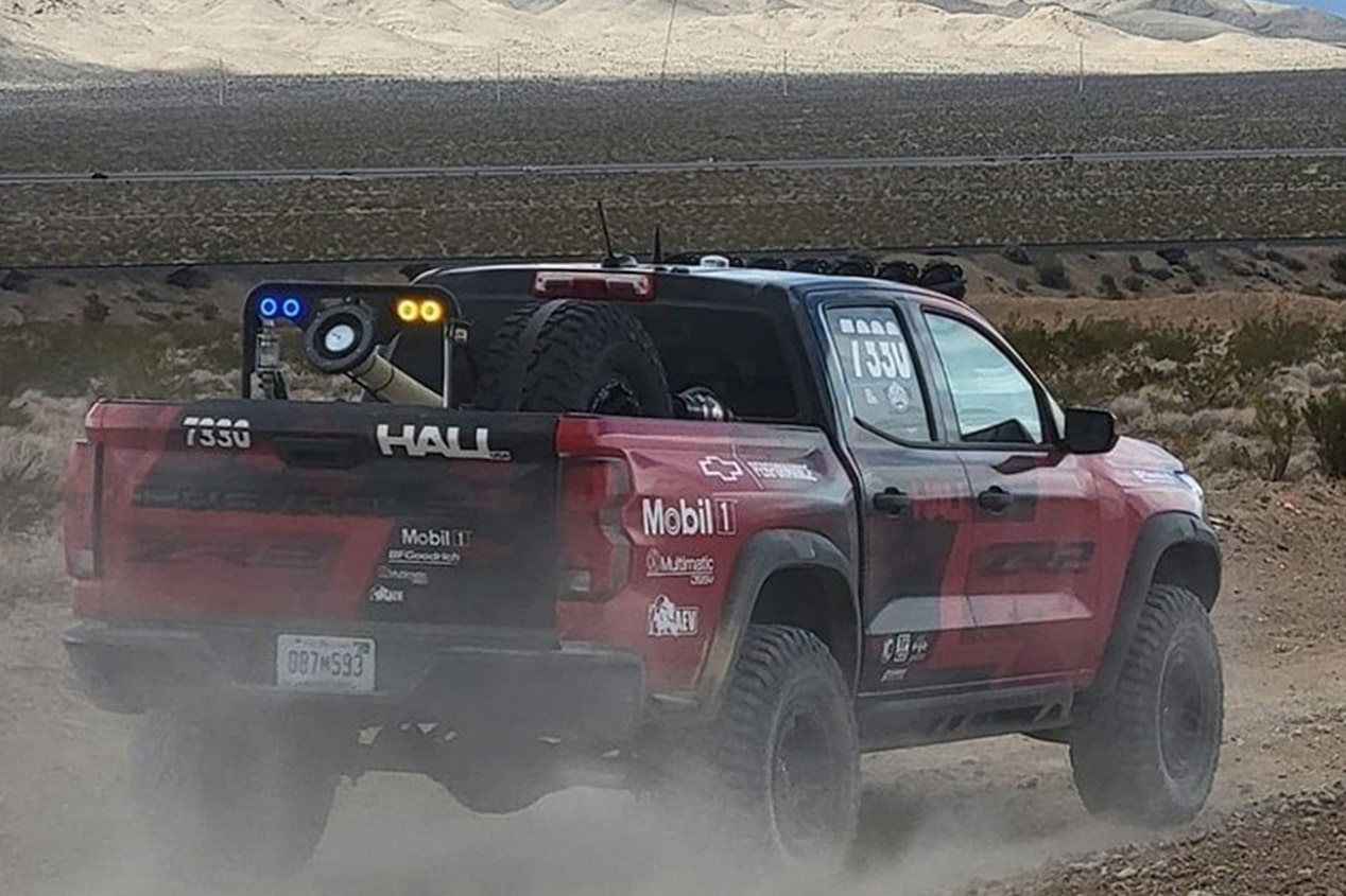 Rear View of a Red Truck on a Dirt Road