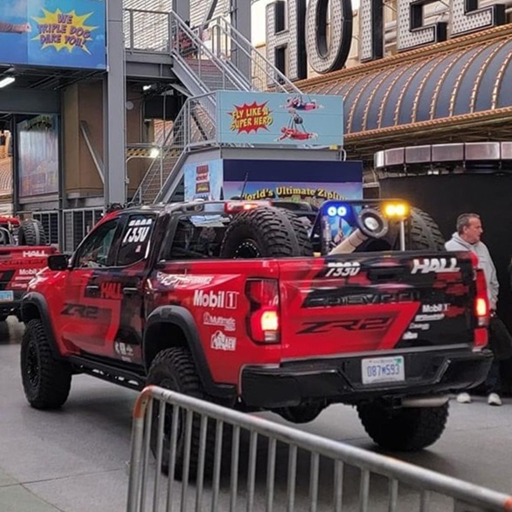 Off-Roading Trucks Lined Up Inside a Performance Hall