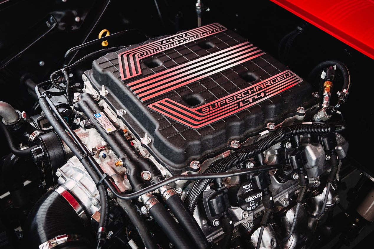 A LT4 Supercharged 6.2L V8 Engine Inside of a Red 1957 Chevrolet 3100 Pickup Truck.