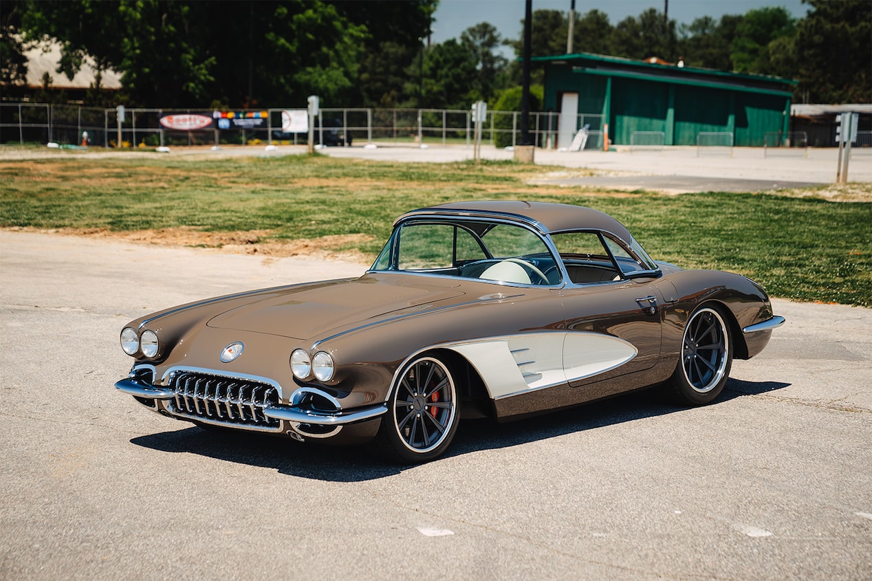 A Side Angled View of a Brown Retro 1958 Chevrolet Corvette Parked on a Gravel Patch.