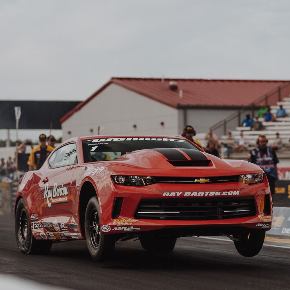 A COPO Camaro Racing on a Track with the Front Tires Up