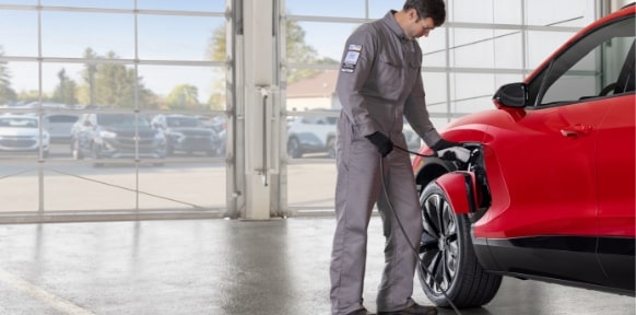A Chevy Technician Services a Chevy EV