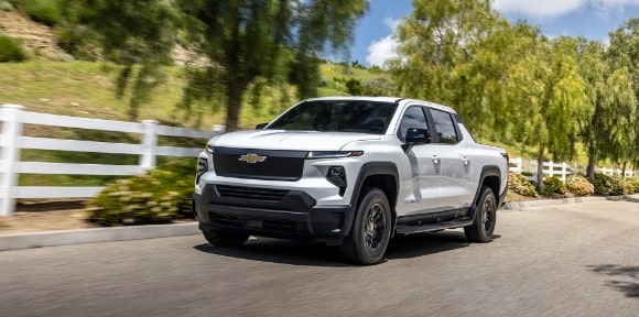 A Chevy EV Truck Drives Through the Countryside