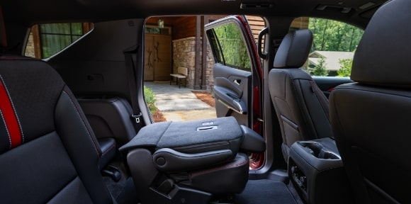 A Chevy Interior with a Folded Seat and Open Car Door