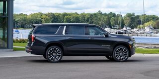 Profile View of the 2026 Chevrolet Suburban SUV Passenger Side Parked Near a Boating Dock