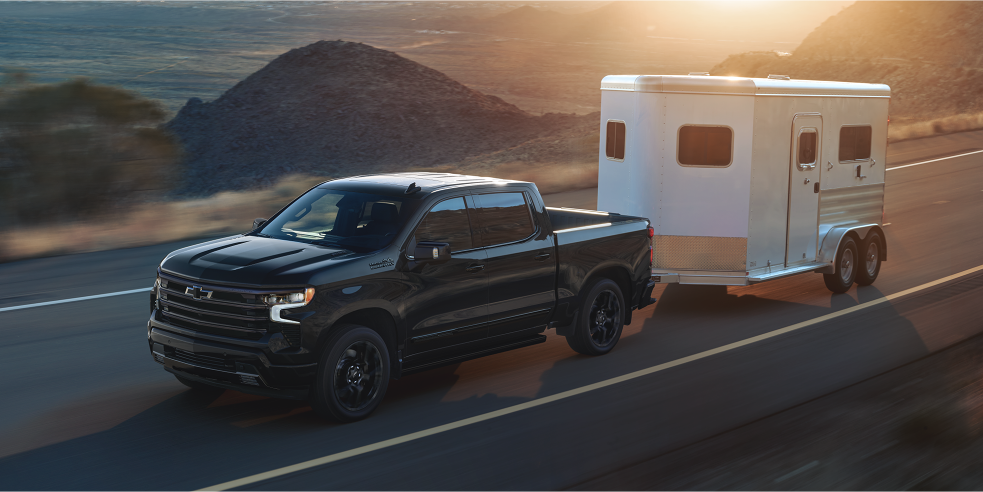 2026 Chevy Silverado LD Towing a Small Trailer on a Highway
