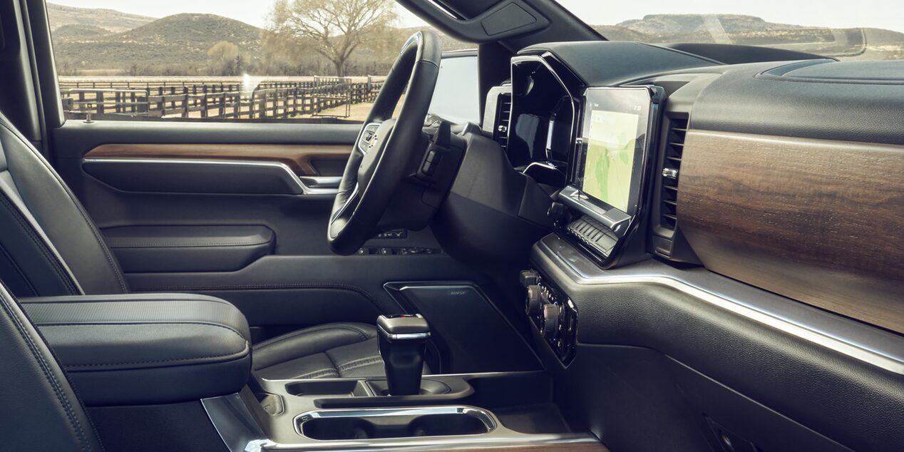 Interior of a 2026 Chevy Silverado LD Featuring a Large Touchscreen Display Wood Trim Accents and Modern Controls