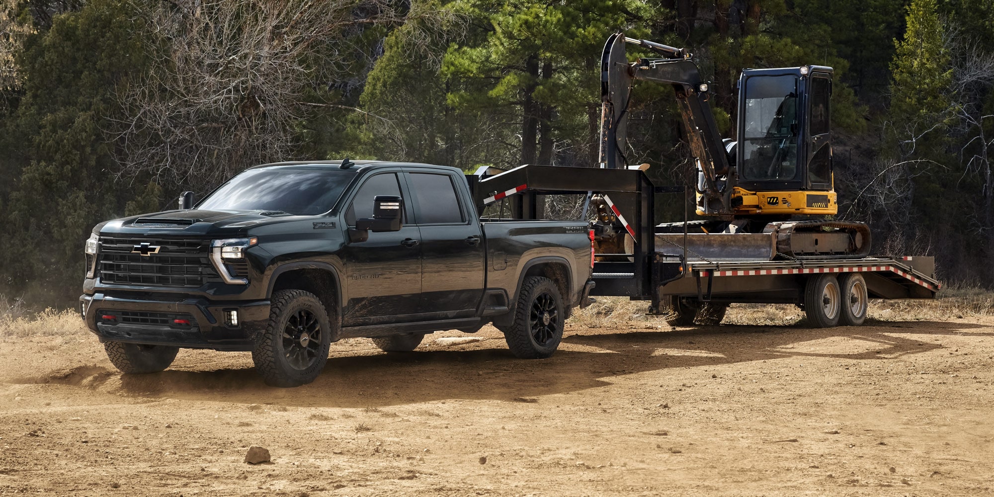 View of the 2026 Chevy Silverado with Trail Boss Trim Towing a Bulldozer