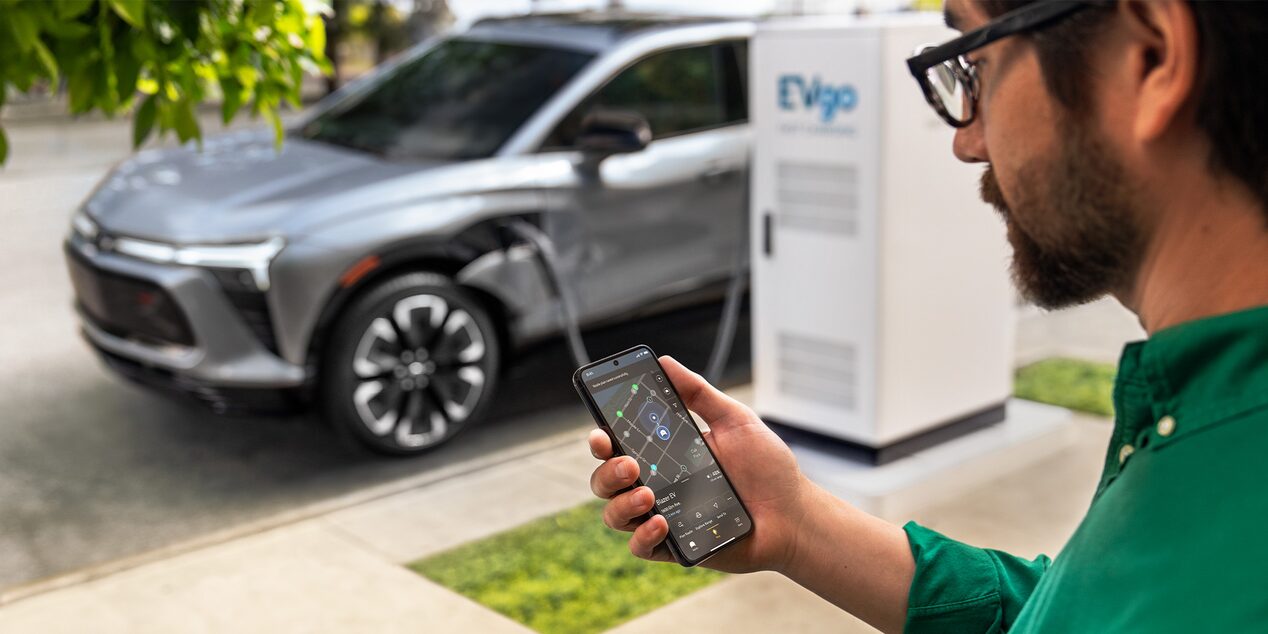 A Man Using his MyChevrolet App to Find a Public EV Charging Station
