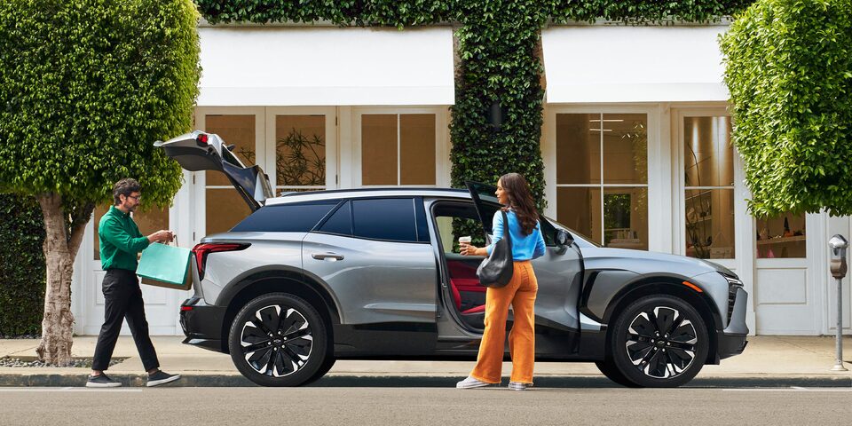 Couple Loading Shopping Bags into Their Chevy Blazer EV