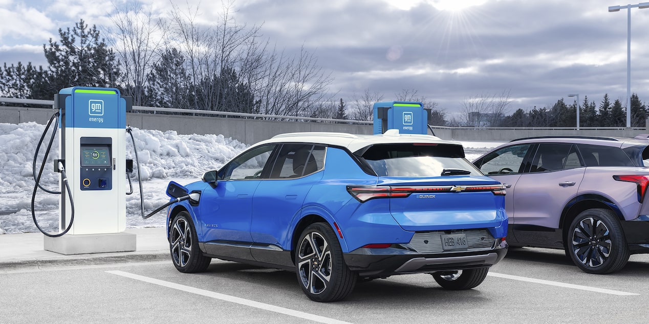 Chevy Equinox EV Parked at a GM Charging Station in a Snowy Parking Lot