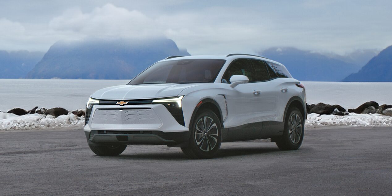 Chevy Blazer EV Parked in Front of a Lake with Mountains in the Background