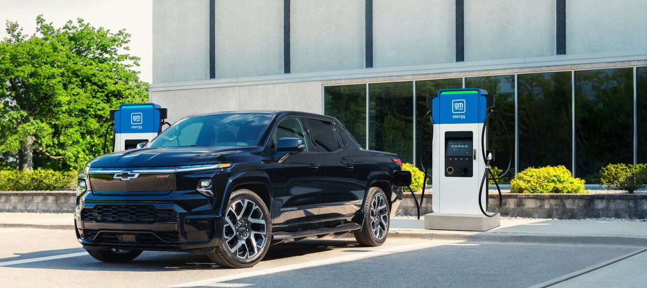 A 2025 Black Chevrolet Silverado EV at an Outdoor Charging Station