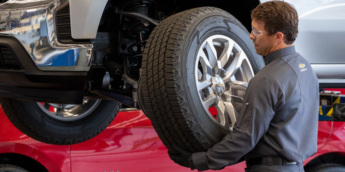 A Chevy Maintenance Man Replaces the Tires on a Chevy Vehicle