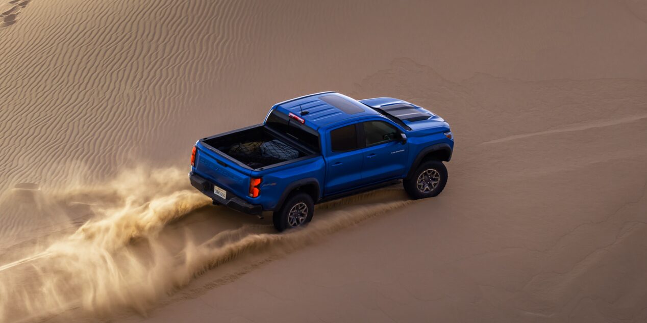 Blue ZR2 Tearing Through Sandy Offroad Terrain