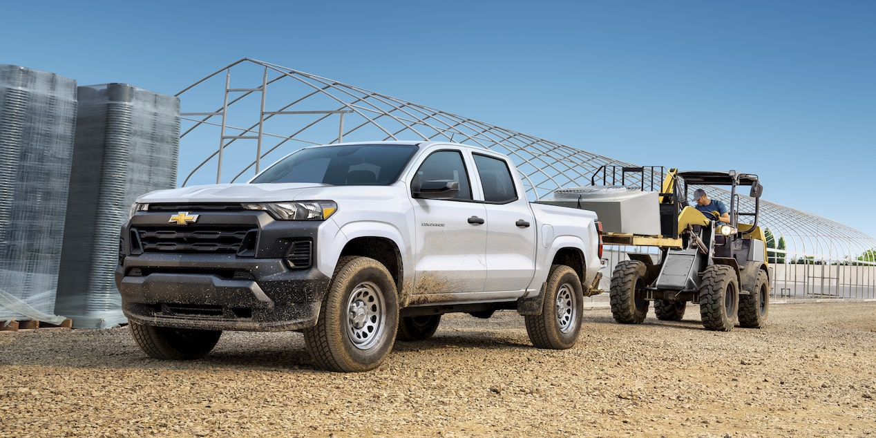 A Forklift Loading The Bed Of The 2025 Chevy Commercial Colorado With Construction Materials