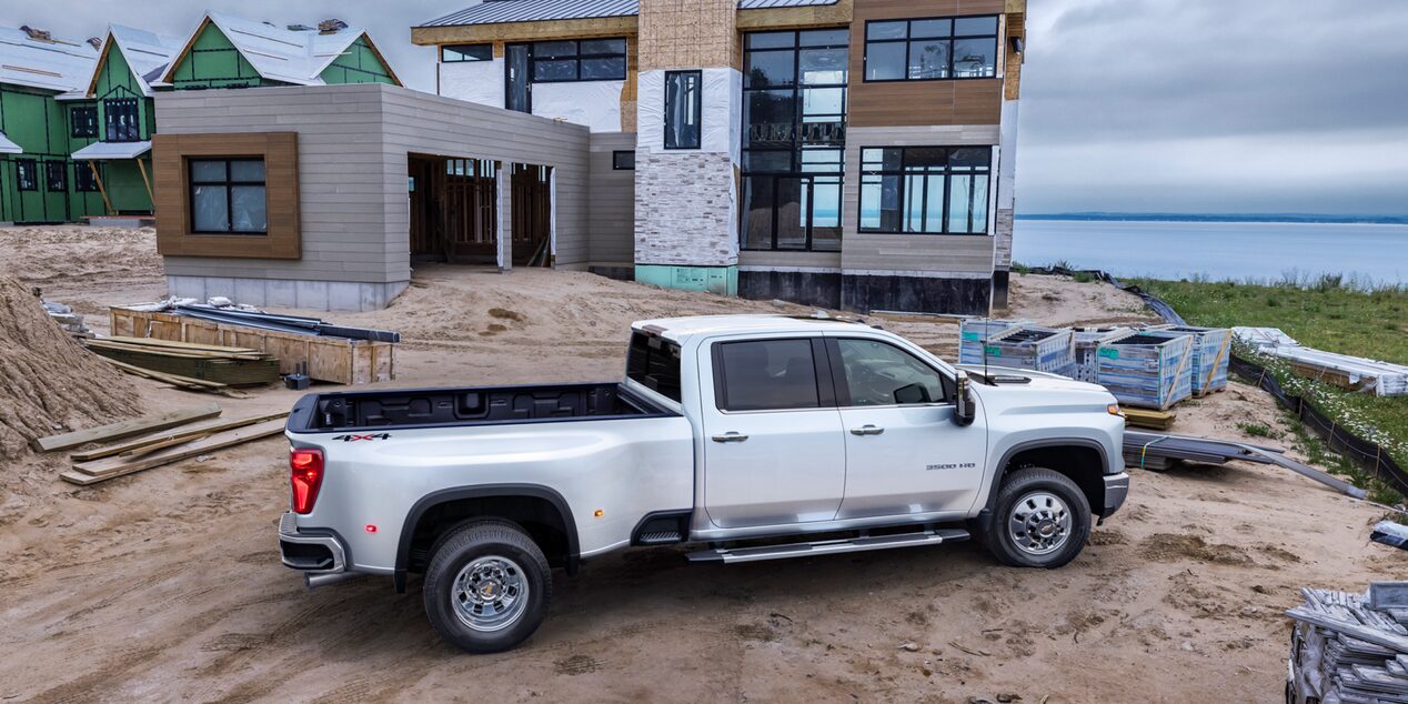 Rear Three Quarters View of a White 2025 Chevy Silverado HD Truck on a Construction Site