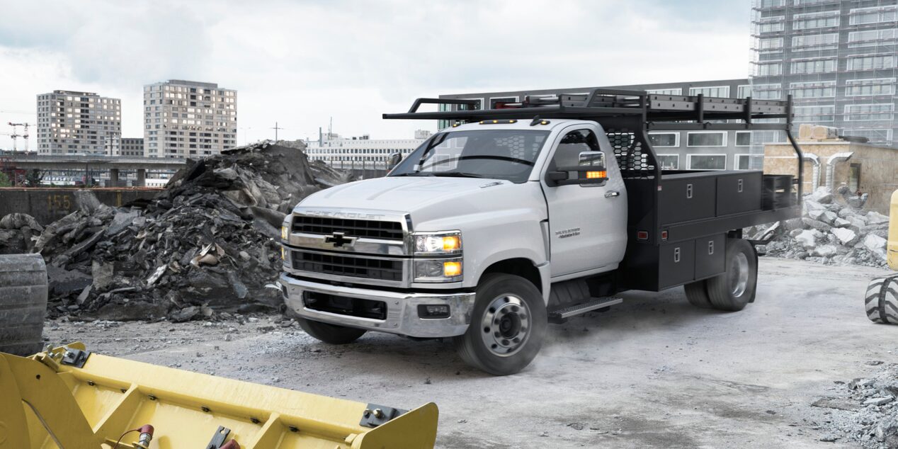 2025 Chevy Silverado Medium Duty Chassis Cab Parked on a Construction Site With Piles of Stone Nearby