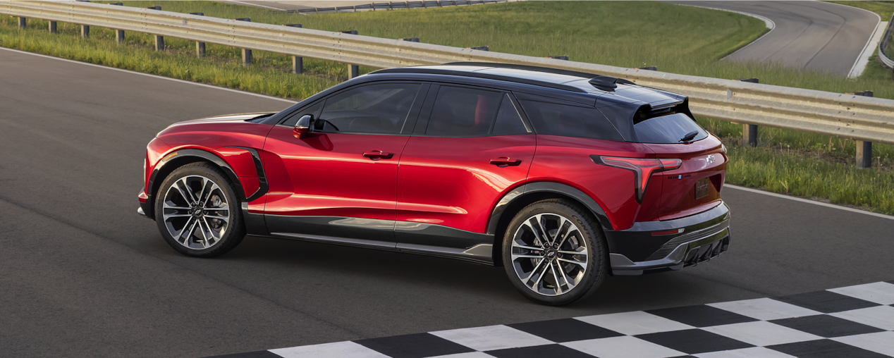 Side View of a Red 2025 Chevy Blazer EV on a Racetrack