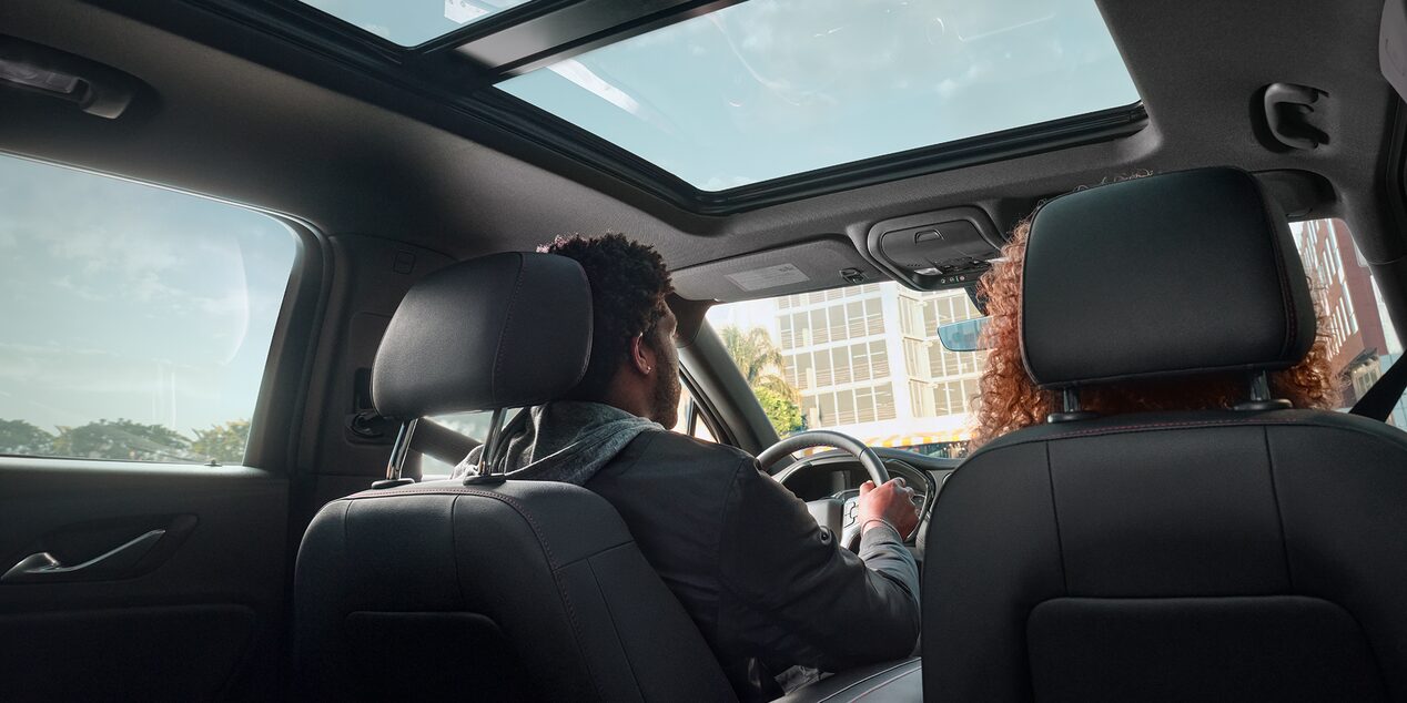 Rear View of a Man and Woman Sitting on the Front Seats of a Chevy Blazer