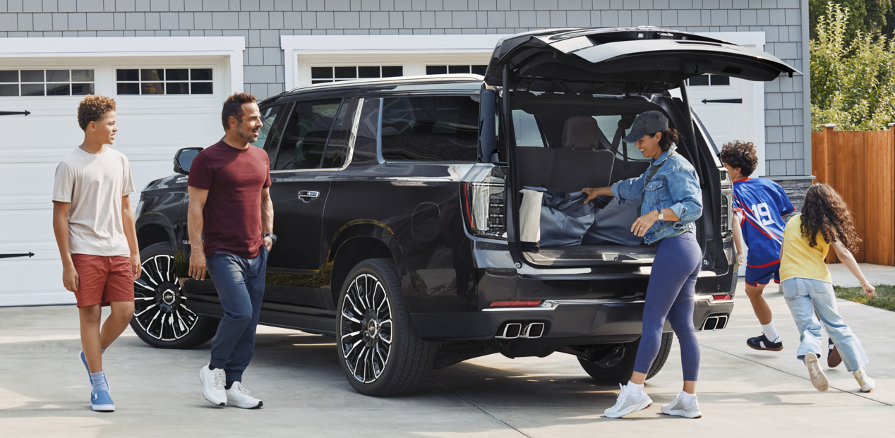 A Family Loading Up Their 2025 Chevy Suburban in Their Driveway