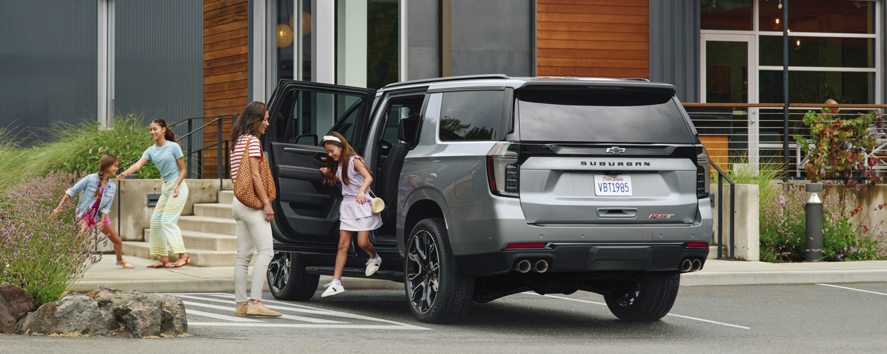 A Child Exiting the Backseat of Their 2025 Chevy Suburban