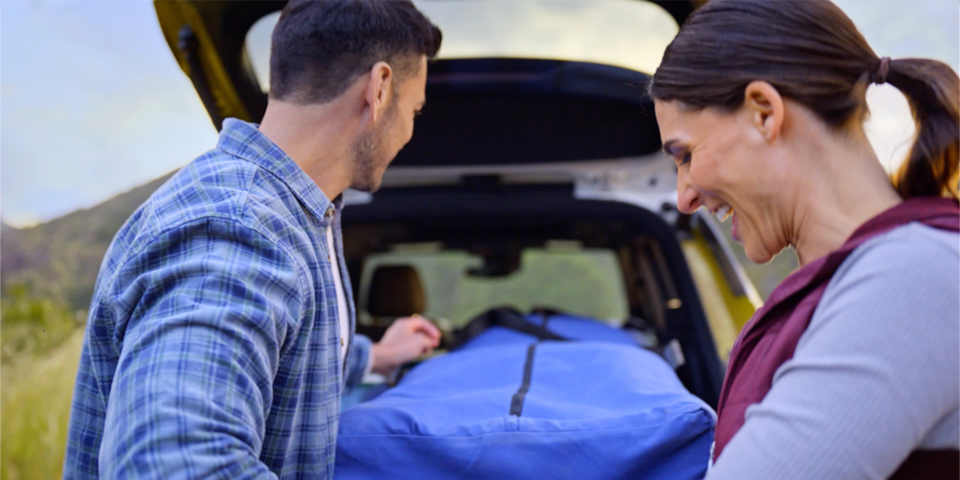A Couple Loading Camping Gear in Trunk of the 2025 Chevy Trailblazer