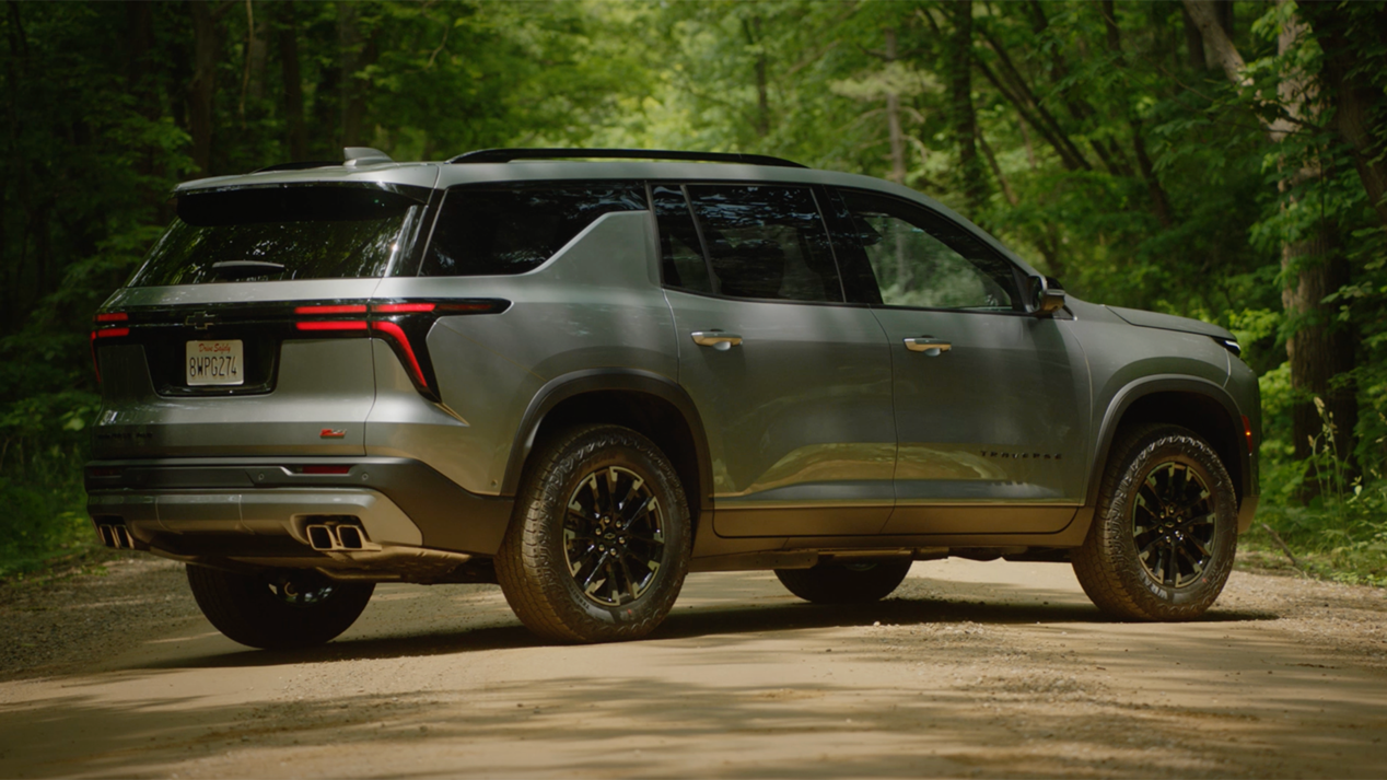 Three Quarters Rear View of a 2025 Chevy Traverse Surrounded by Trees