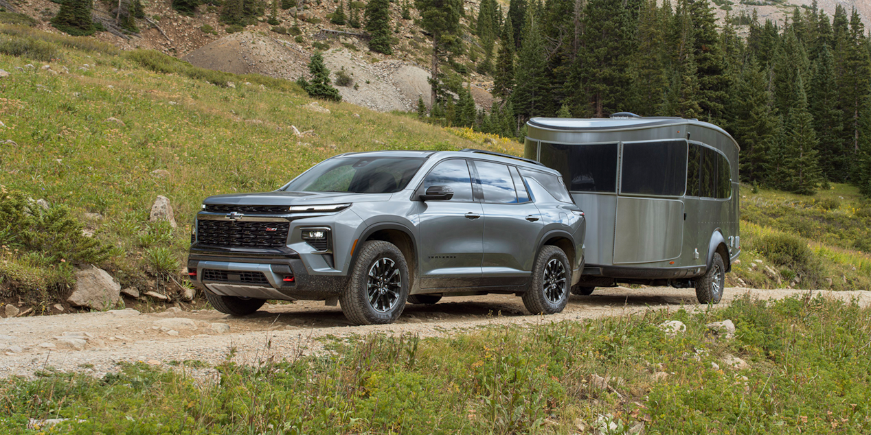 Front Three Quarter Exterior View of a Gray Chevy Traverse on a Dirt Road