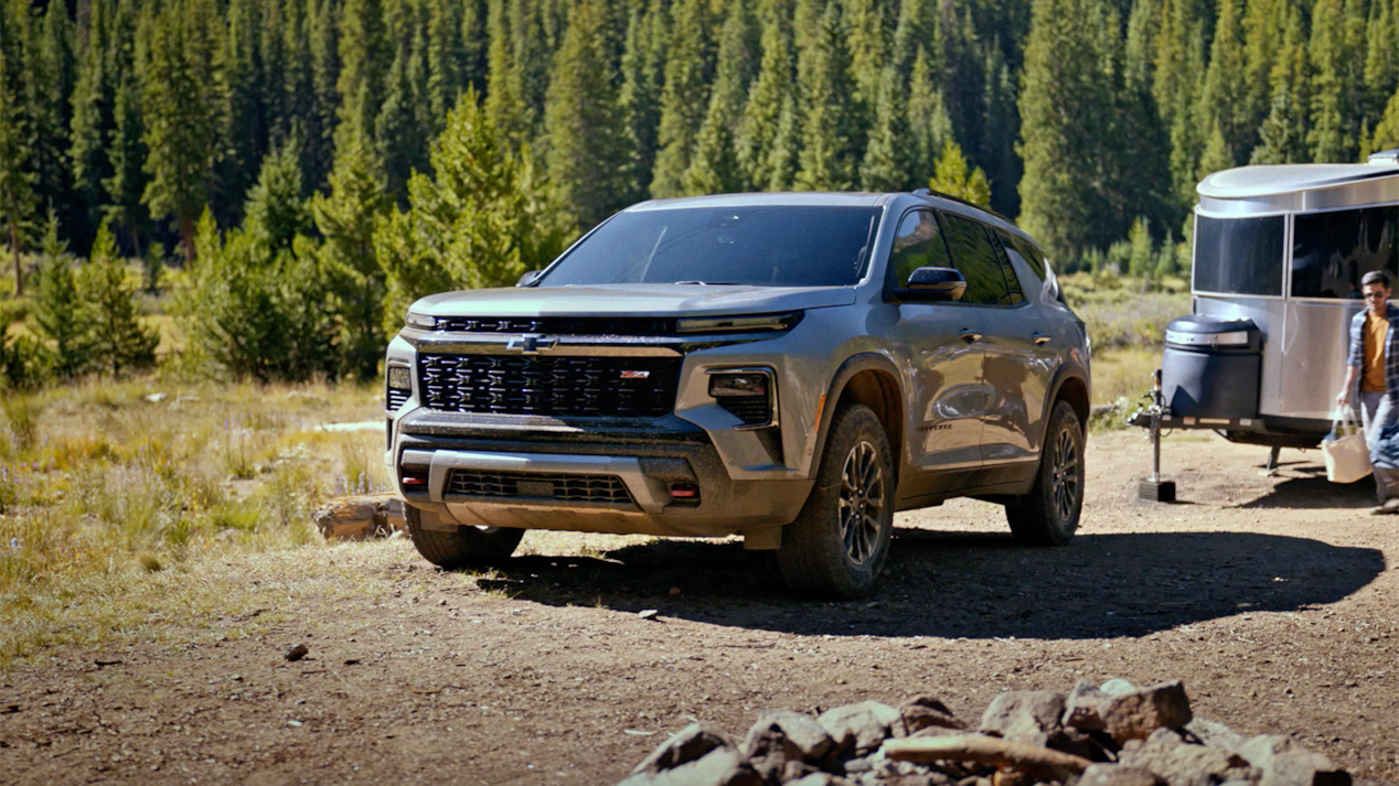 Three Quarters View of a Silver 2025 Chevy Traverse in Nature