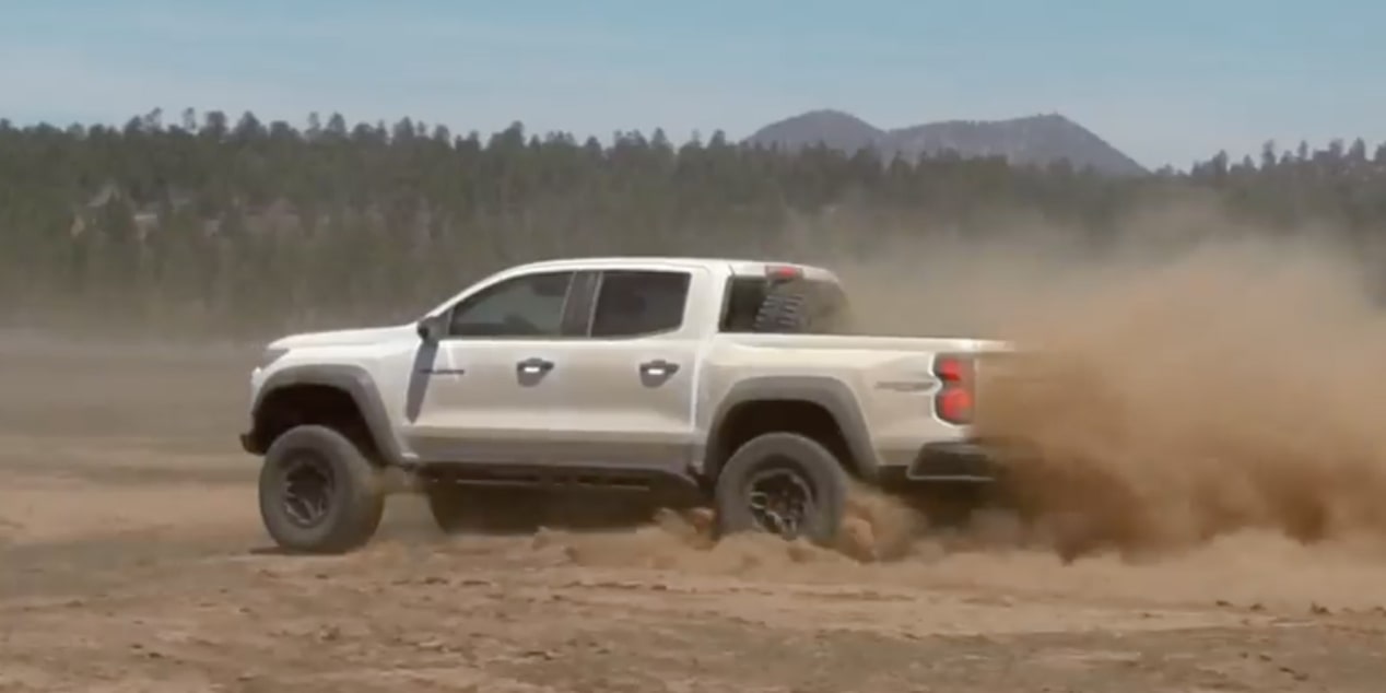  Three Quarters Rear View of a White 2025 Chevy Colorado Drifting on a Desert